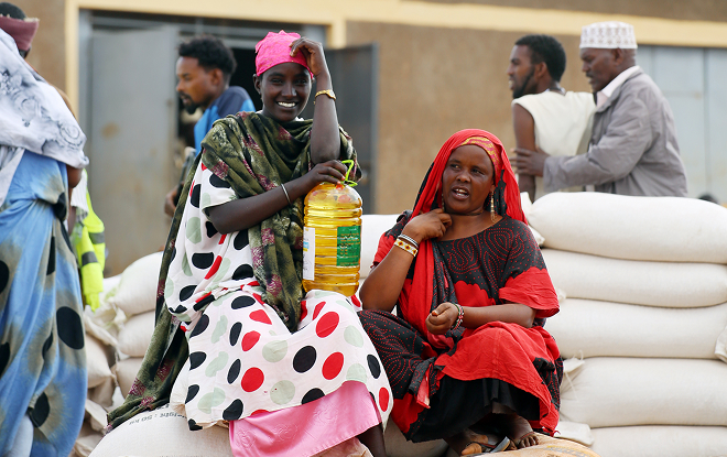 Two women sit on bags of grain from Tearfund and MFAT, distributed by TDA in Moyale southern Ethiopia.