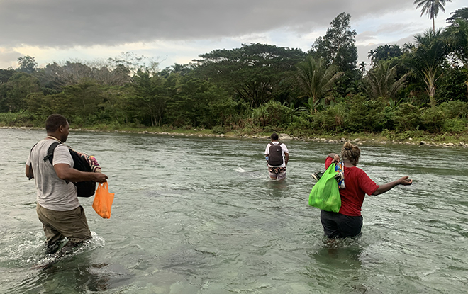 Our fieldwork team is crossing the river to go to Ao'o village