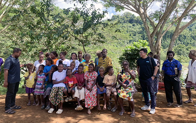 Tearfund and HOPE Trust staff with community members in Ao'o village
