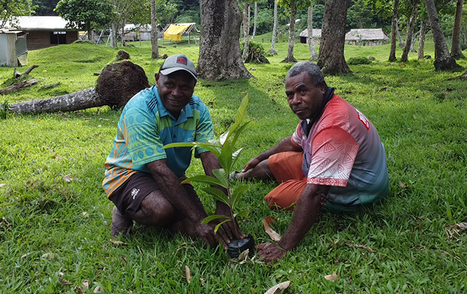 Nasituan staff member and South River Chief planting a seedling in the project area, Middlebush